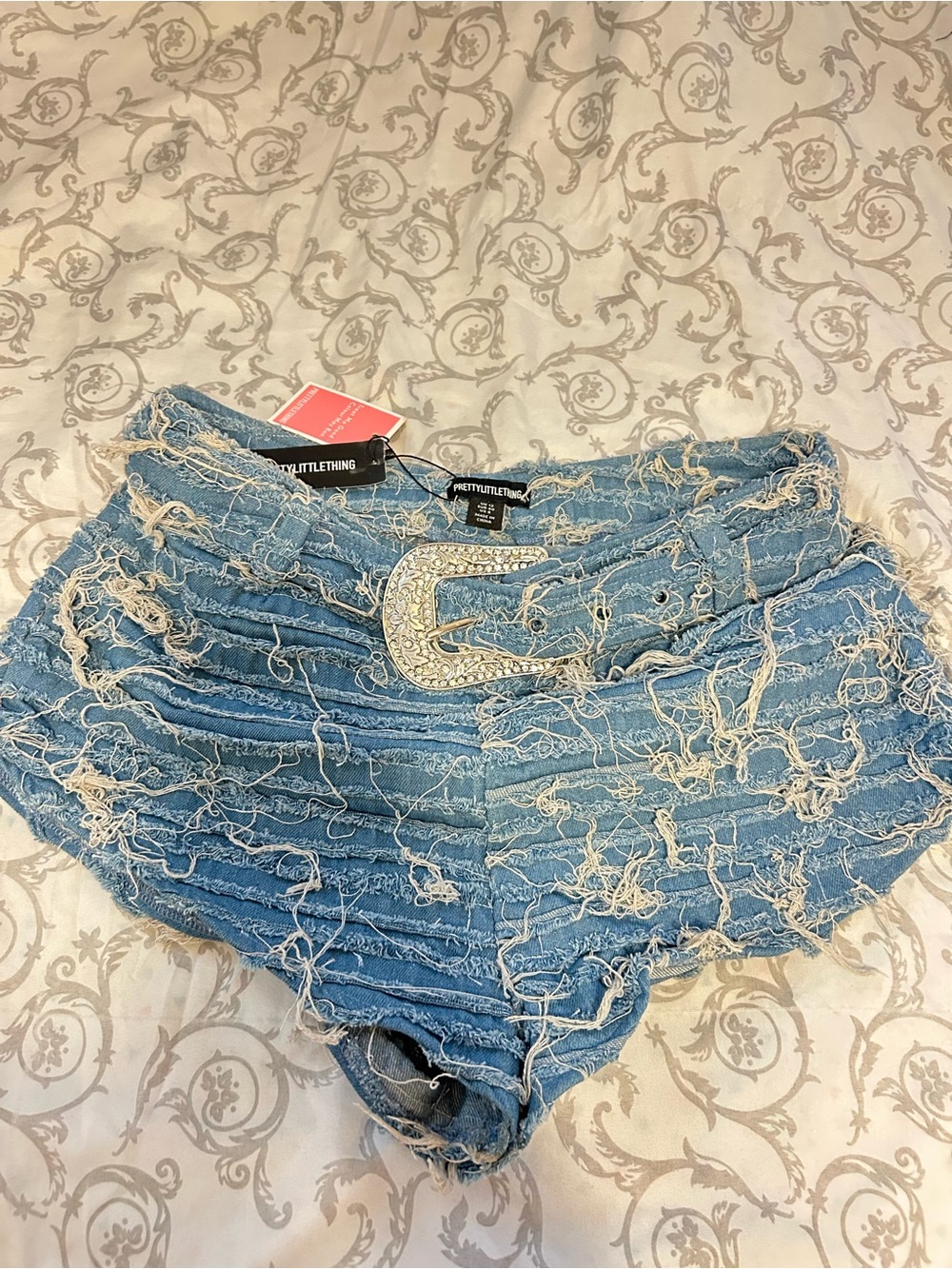 PrettyLittleThing Light Blue Distressed Denim Shorts with Rhinestone Buckle